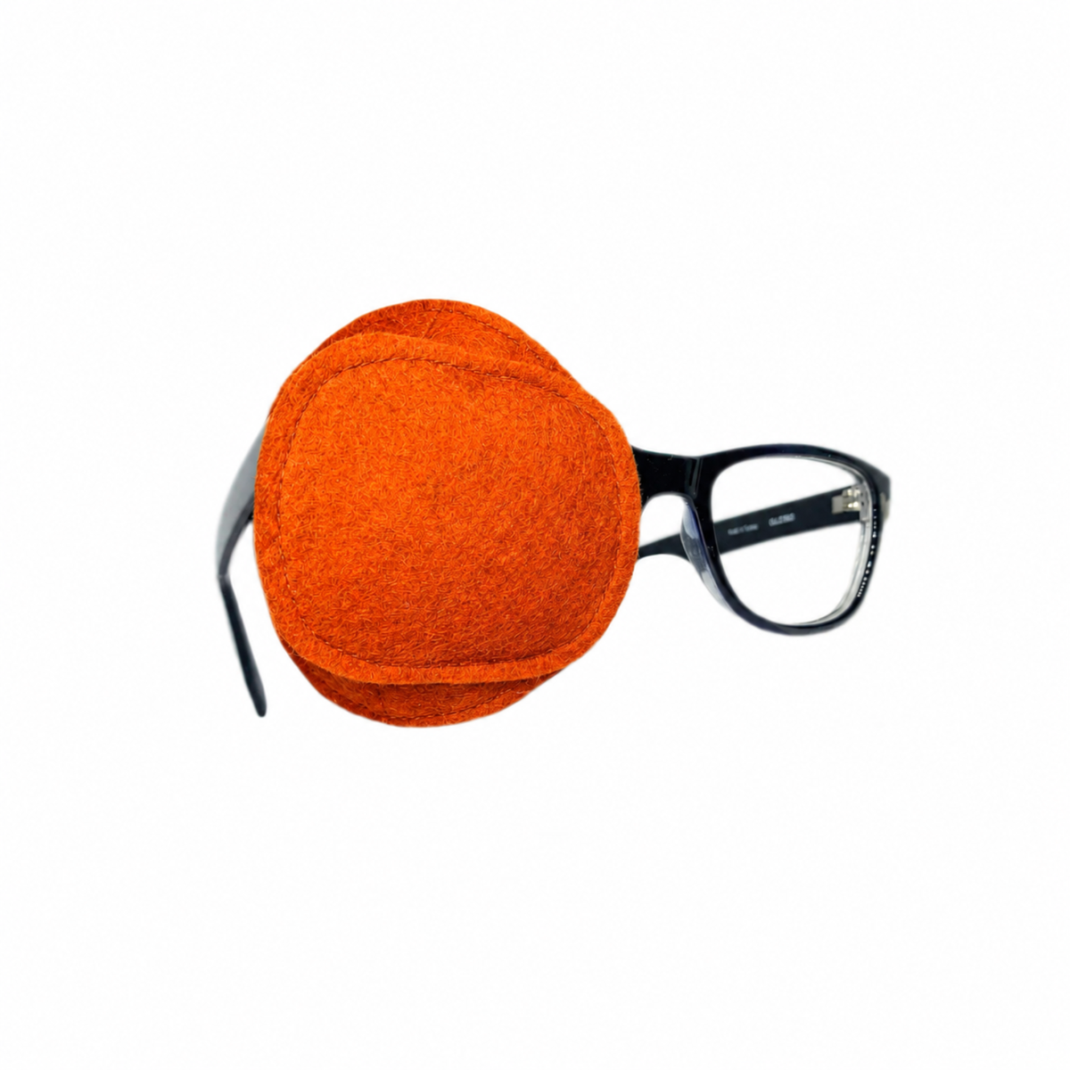 Orange wool felt eye patch with folded design and visible stitching, shown on glasses and as a close-up