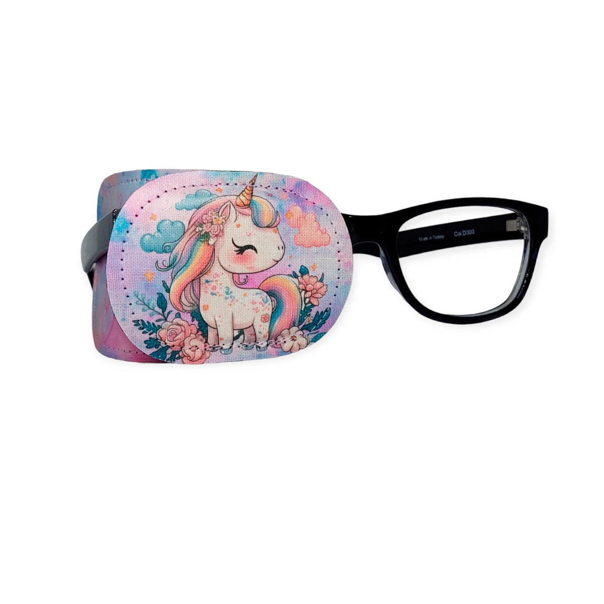 Pastel unicorn eye patch with flowers and rainbow details, shown slipped over black-framed glasses