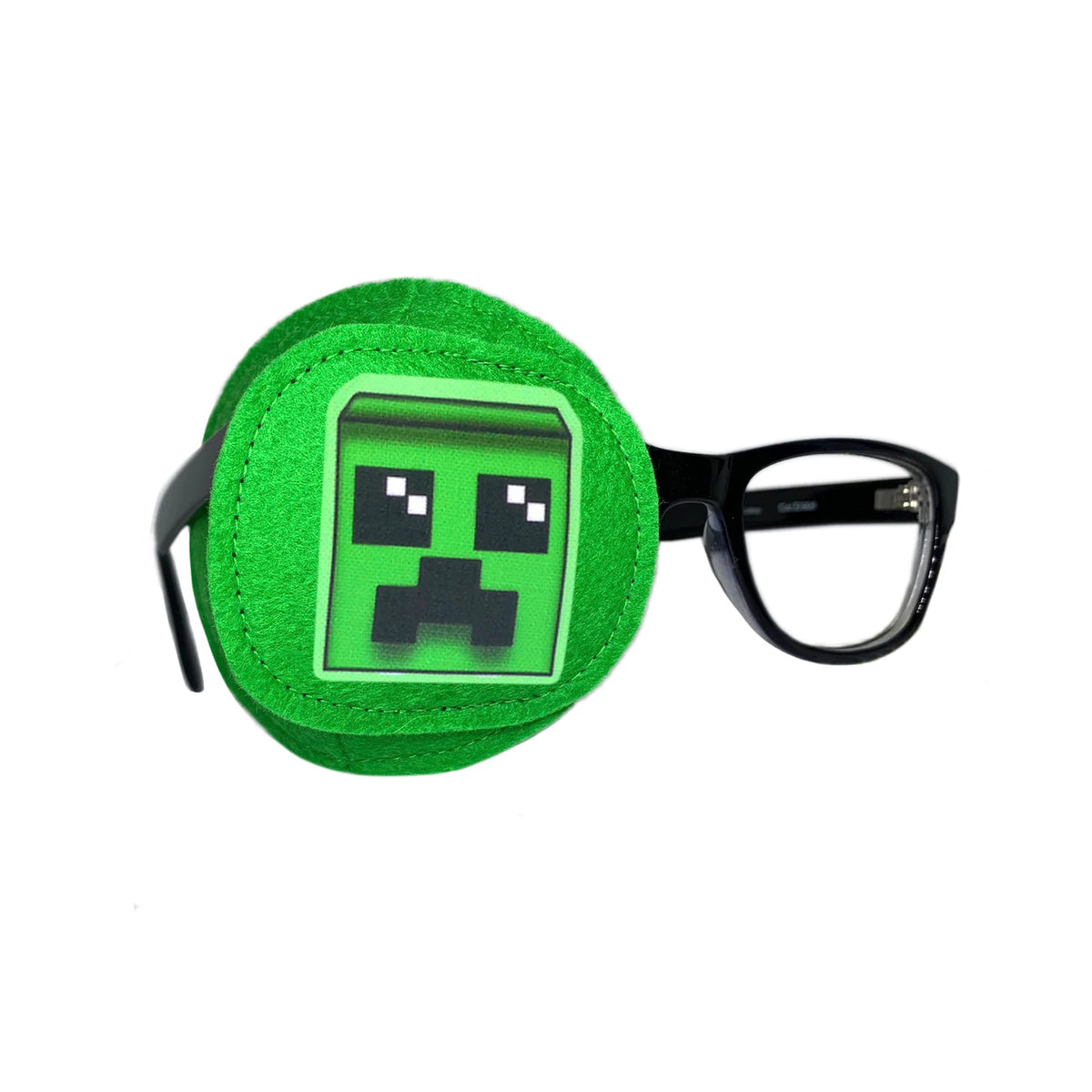 Bright green full coverage eye patch with pixel monster face on black-framed glasses